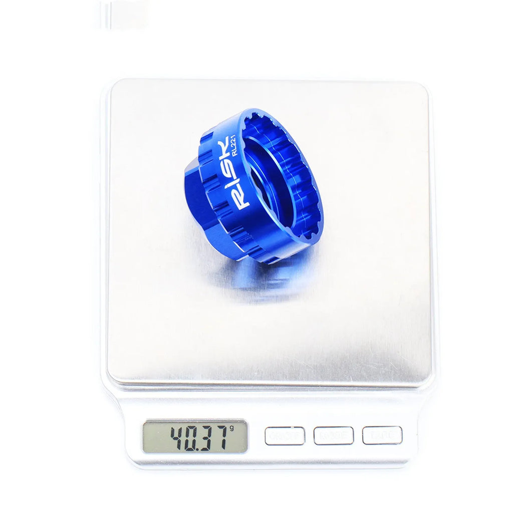 Blue aluminium alloy bicycle chainring removal tool for 12-speed direct mount disc systems with a wrench.