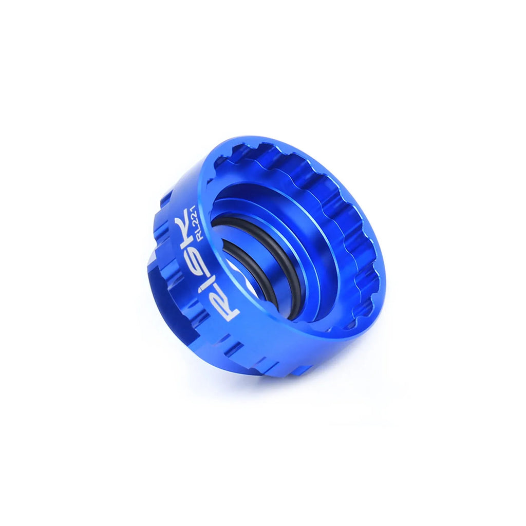 Blue aluminium alloy bicycle chainring removal tool for 12-speed direct mount disc systems with a wrench.