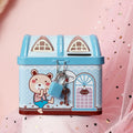 Blue house-shaped tinplate piggy bank with round coin slot on desktop.