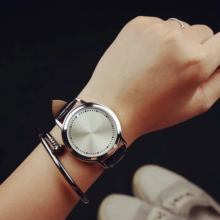 Electronic digital watch with blue LED light display showing numbers, available in black and white colours