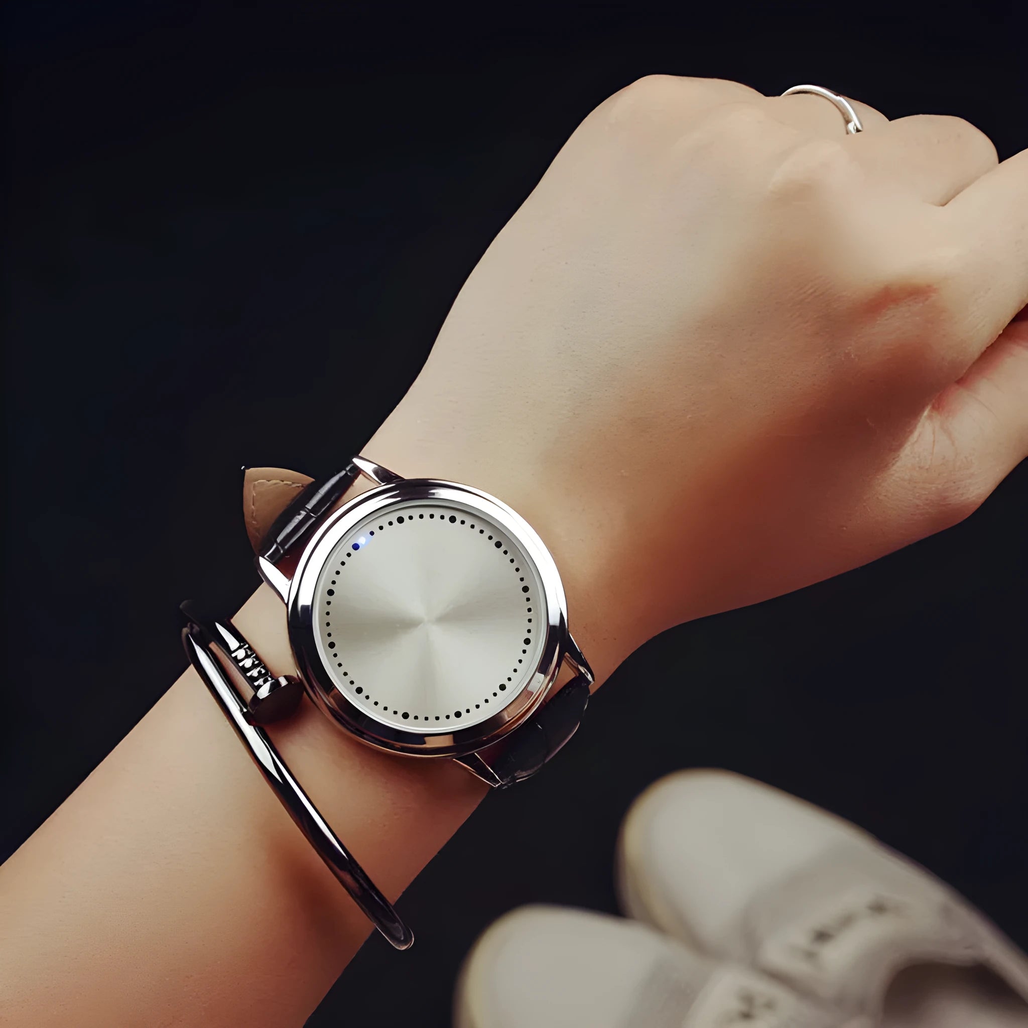 Electronic digital watch with blue LED light display showing numbers, available in black and white colours