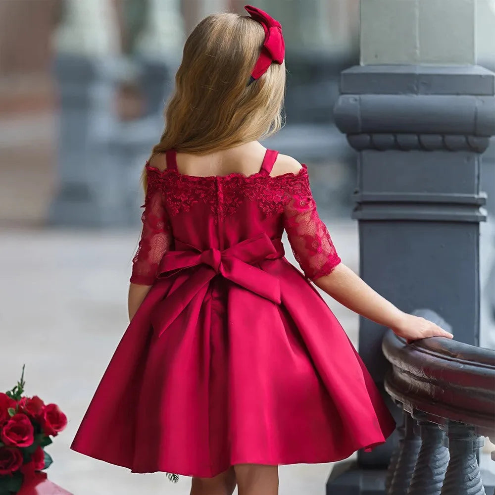 Simple lace-trimmed girls dress in polyester fibre, shown in dark red, green, pink, red or white.