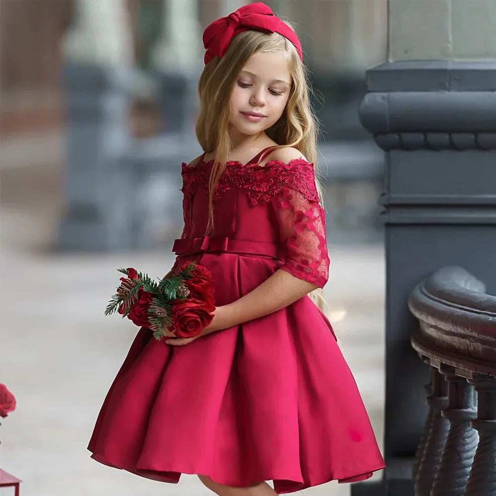 Simple lace-trimmed girls dress in polyester fibre, shown in dark red, green, pink, red or white.