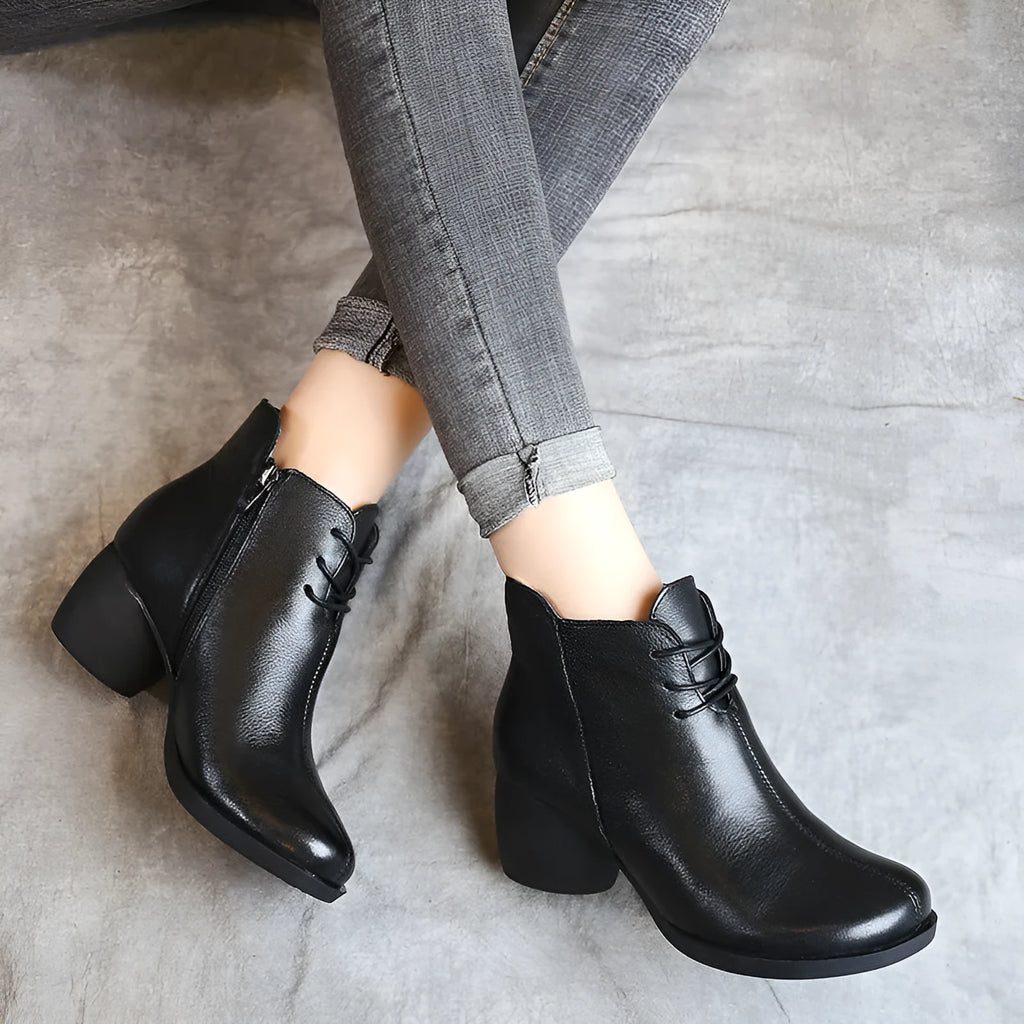 Women's black vintage Martin boots with thick heel and round toe made of leather.