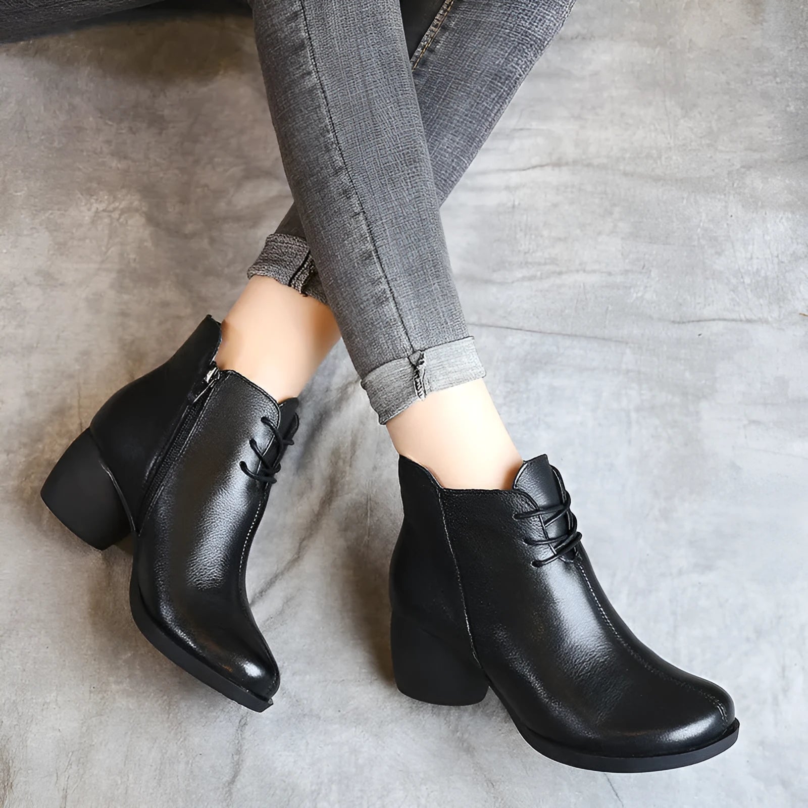 Women's black vintage Martin boots with thick heel and round toe made of leather.