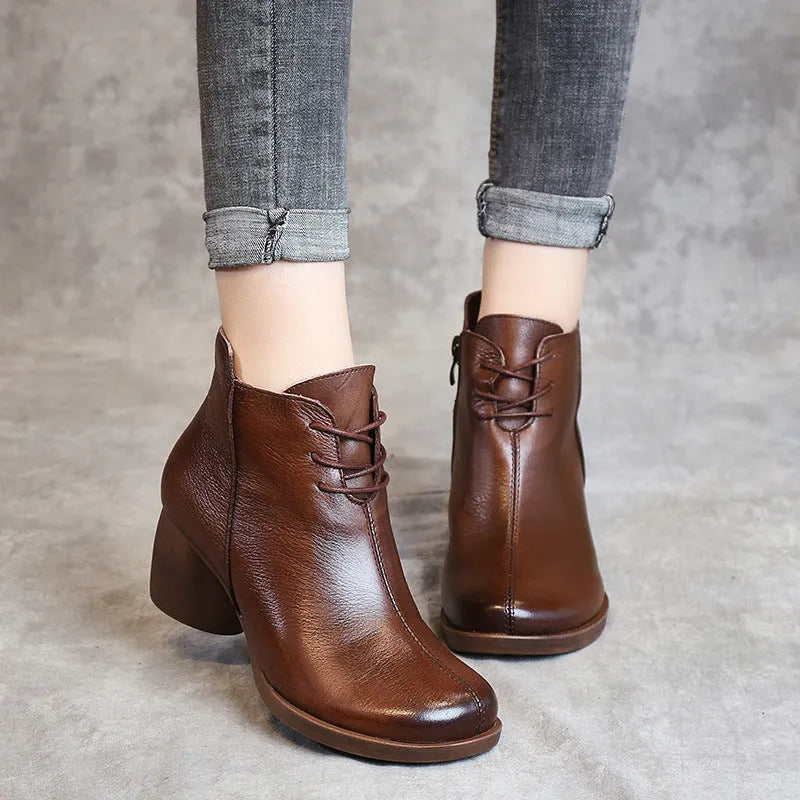 Women's black vintage Martin boots with thick heel and round toe made of leather.