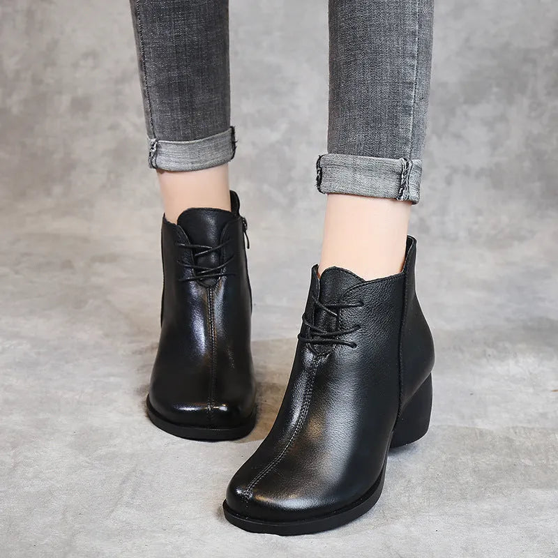 Women's black vintage Martin boots with thick heel and round toe made of leather.