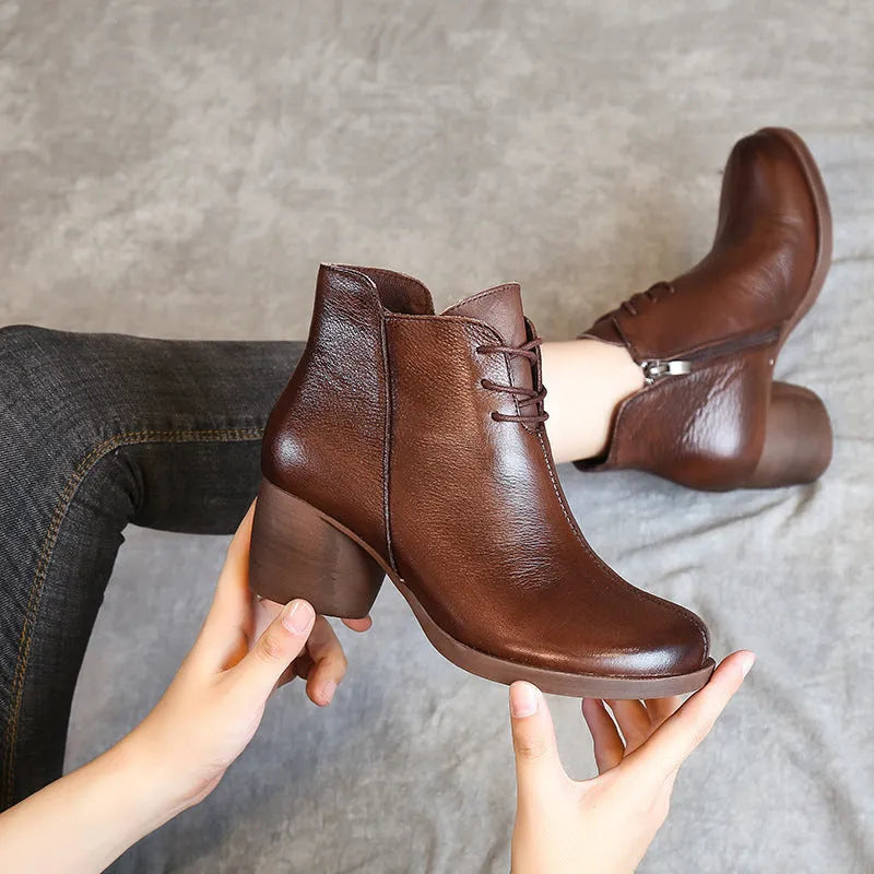 Women's black vintage Martin boots with thick heel and round toe made of leather.