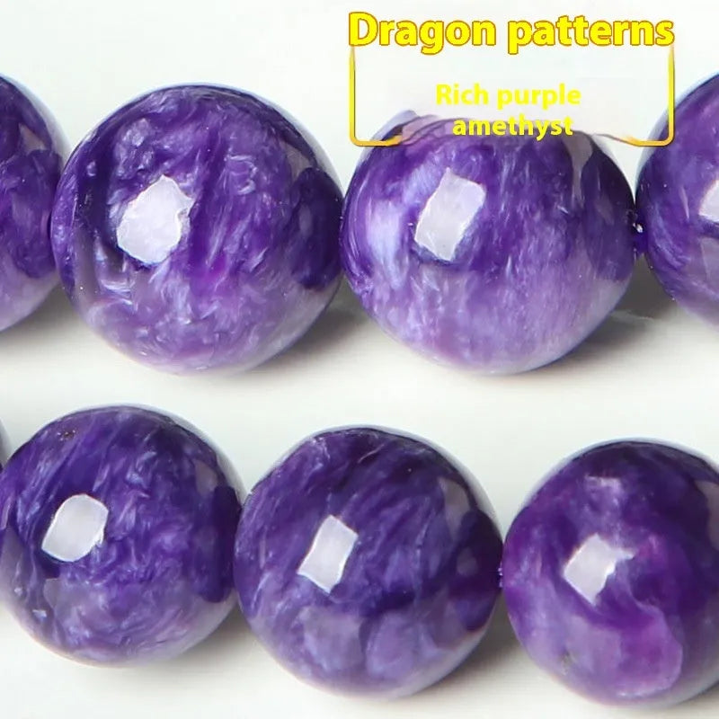Natural transparent charoite crystal bracelet with platinum on a white background, showing bead detail.