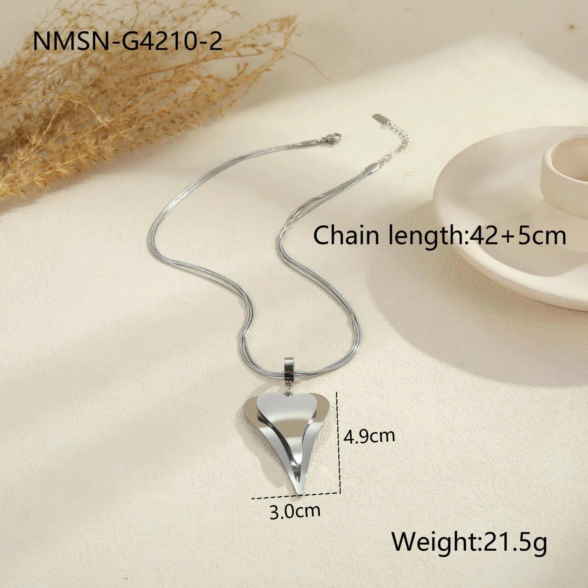 Geometric double heart pendant on a textured snake bones chain necklace in gold or steel finish.