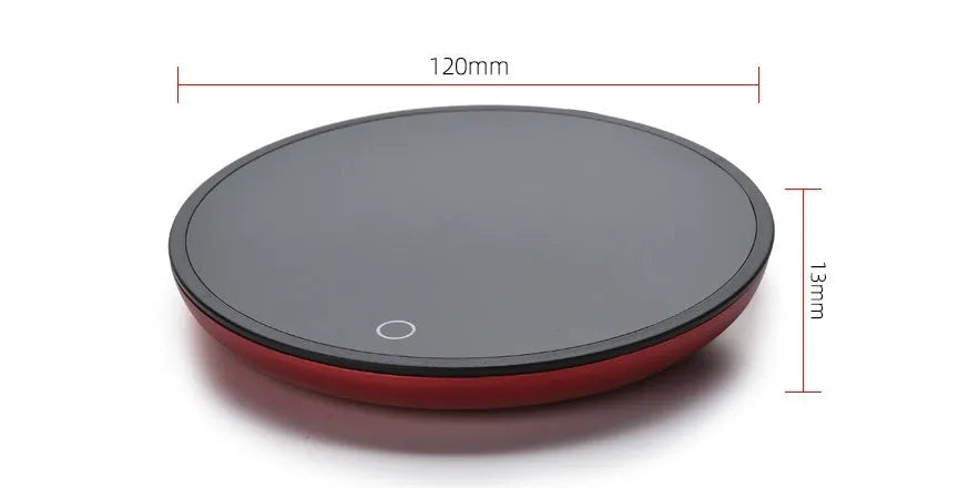 Black coffee mug warmer with temperature control dial on desk
