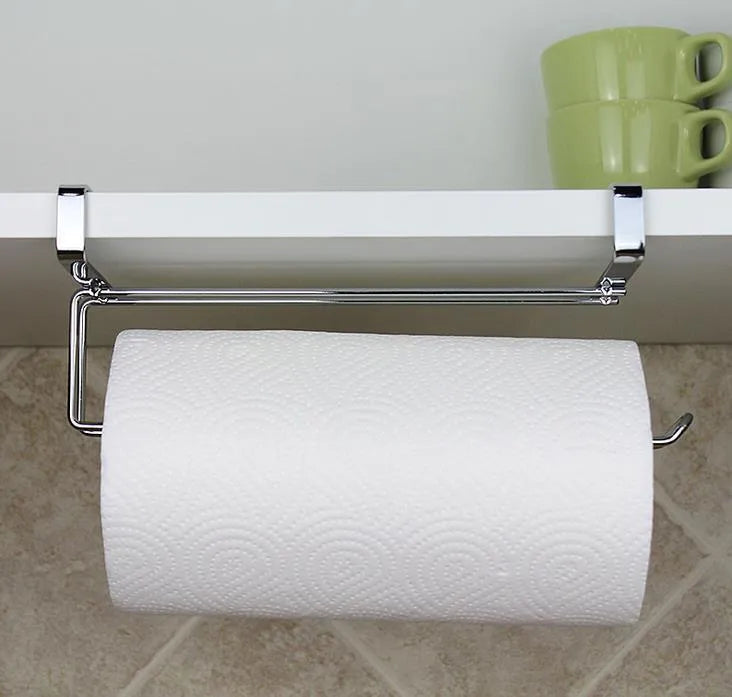Silver stainless steel paper towel rack hanging on kitchen cabinet door