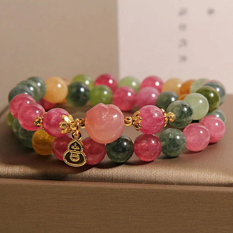 Natural jade colour tourmaline crystal double ring bracelet for women with Buddha head charm on white background