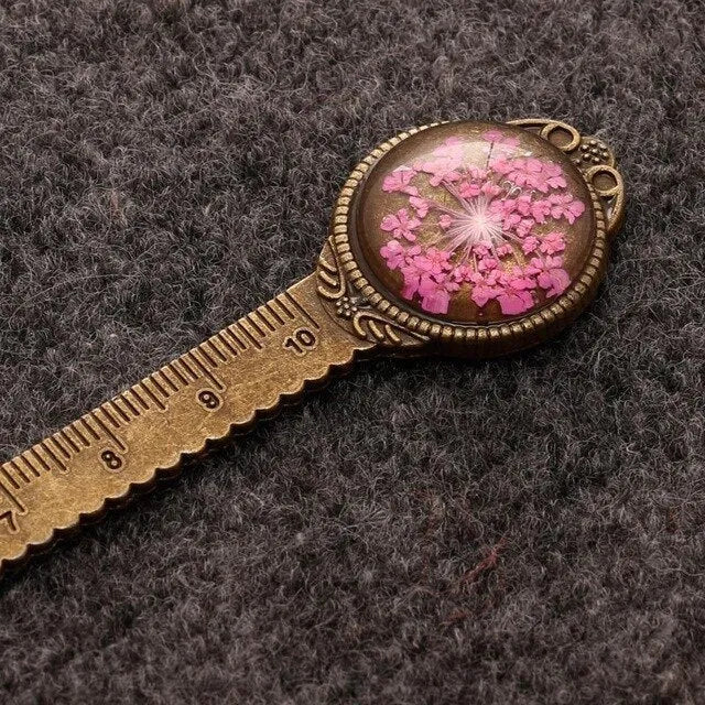 Handmade dried flower bookmark with ruler showing lace flowers, daffodils, and clover at 12cm length