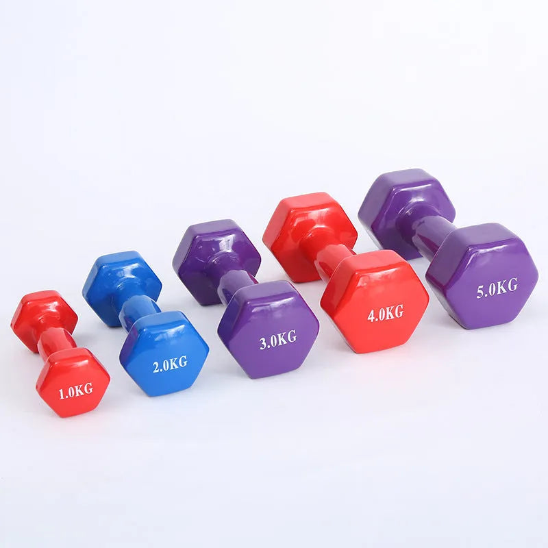 Brightly coloured plastic-coated fitness dumbbells in various weights on a floor.
