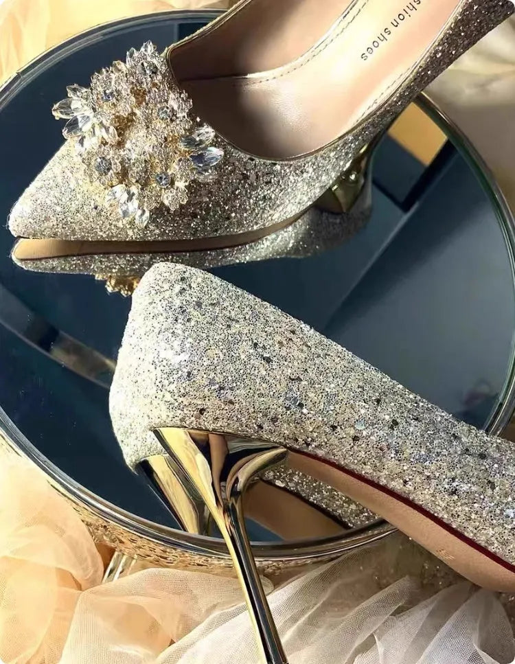 Champagne coloured women's wedding shoes with crystal rhinestones and a pointed toe, shown with a high heel.