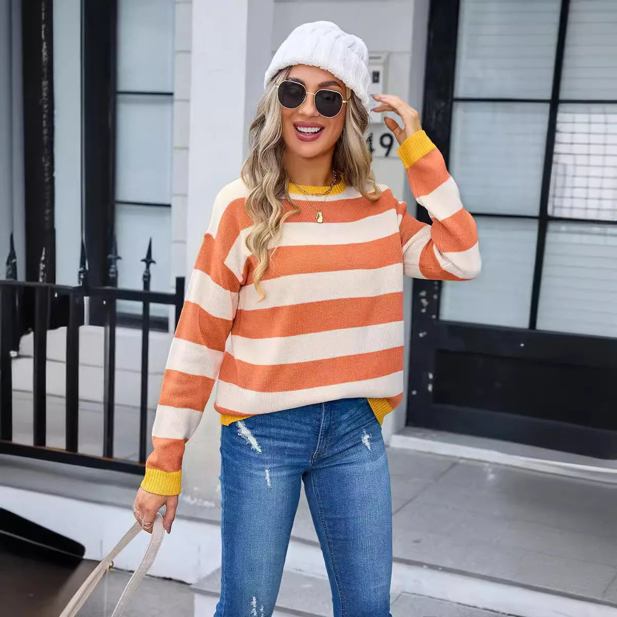 Women's loose fit long sleeve round neck sweater in a striped pattern, shown in a blue colour option.