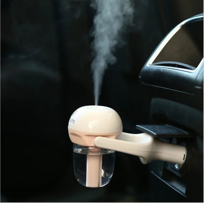 Compact blue portable car humidifier and essential oil diffuser unit on a car dashboard