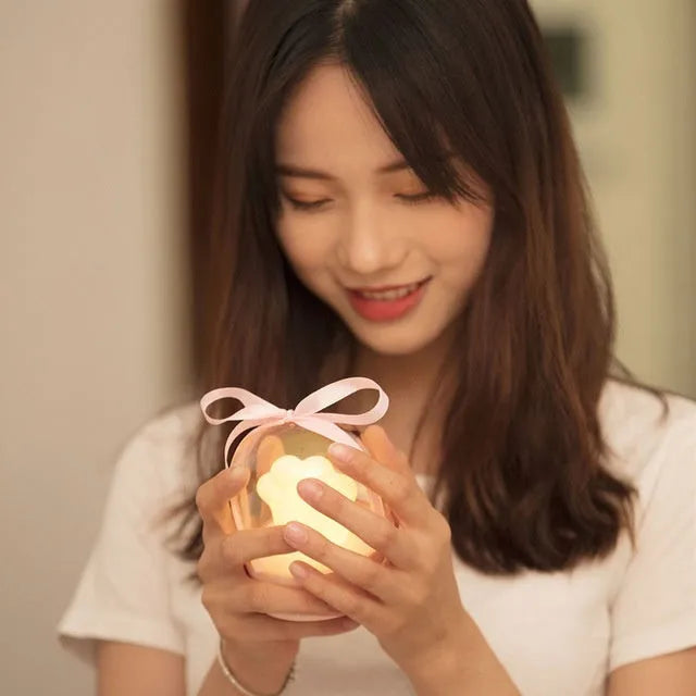 Grey or pink cat paw shaped night light with USB charging port and music box functionality