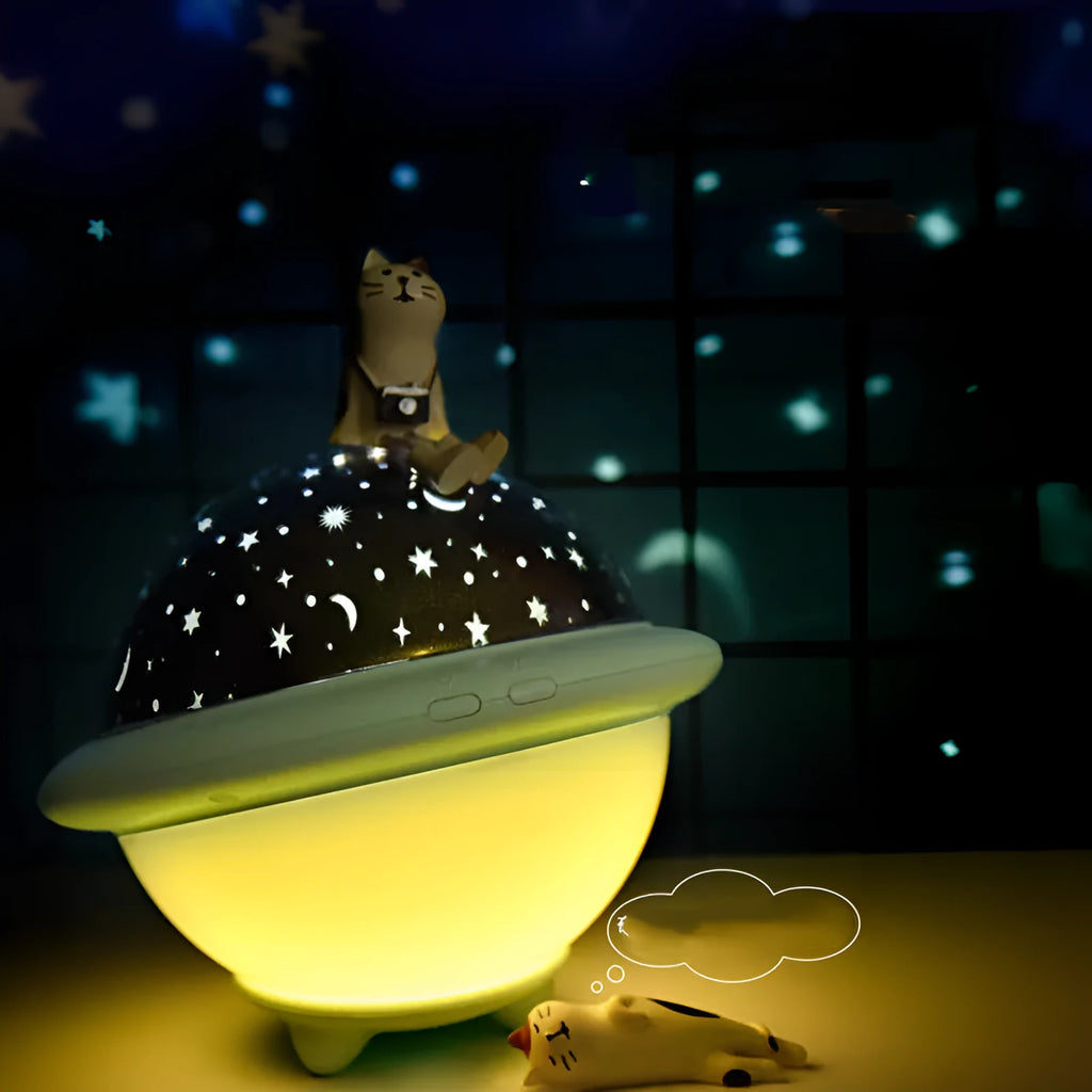 Green UFO-shaped plastic night light projecting starry sky pattern on a wall