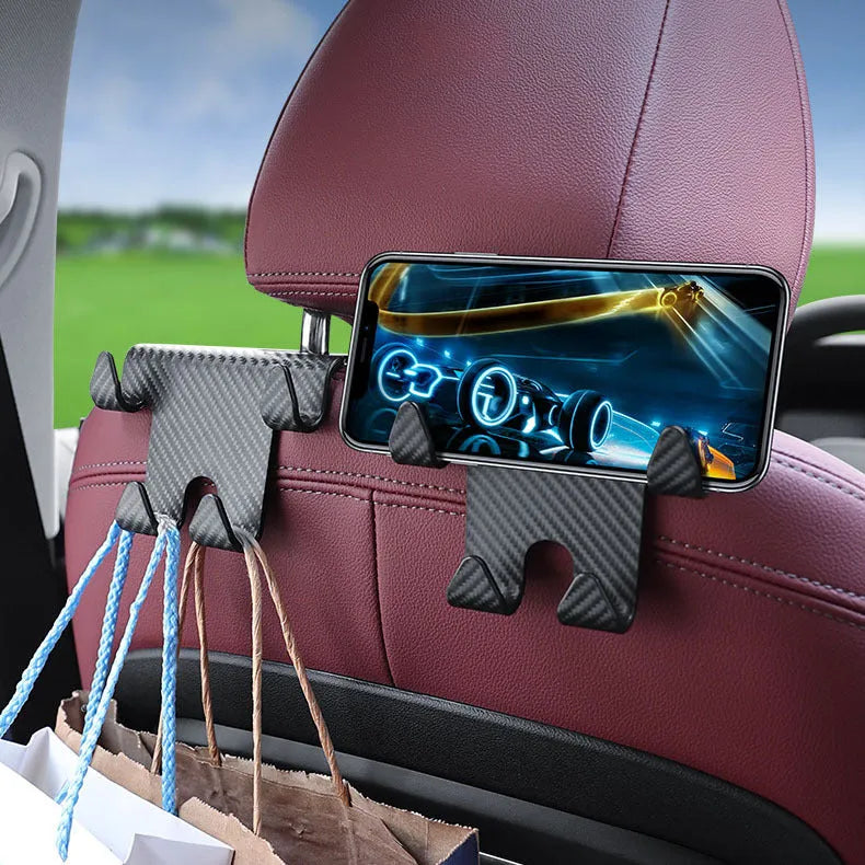Black ABS car storage hook with carbon fibre pattern, combining a bag hook and mobile phone holder for rear seat installation.