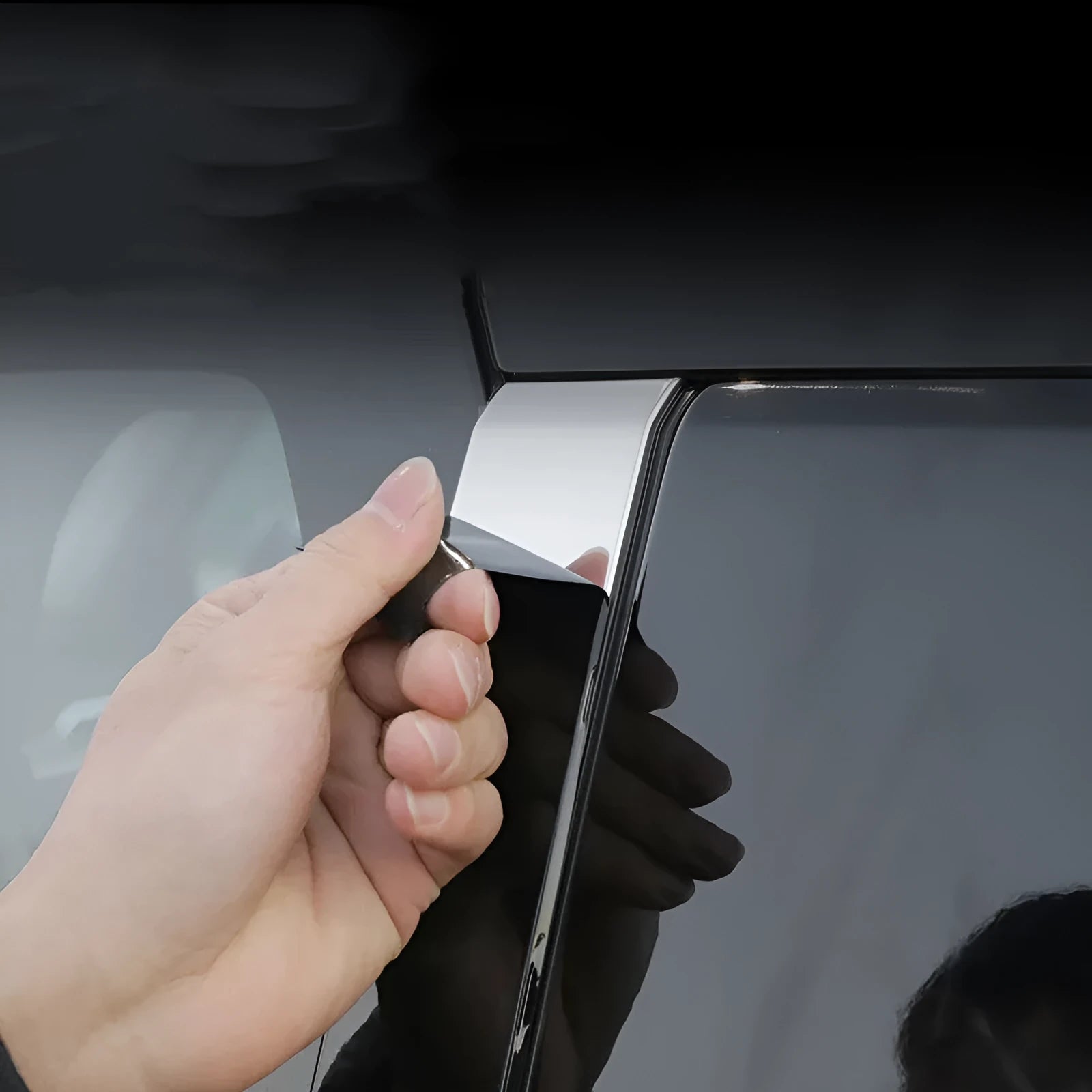 Mitsubishi Outlander car with black protective vinyl film applied to its exterior door and window pillars.