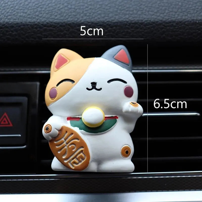 Black cat and white cat resin car vent clip aromatherapy diffuser on a car air conditioning vent.