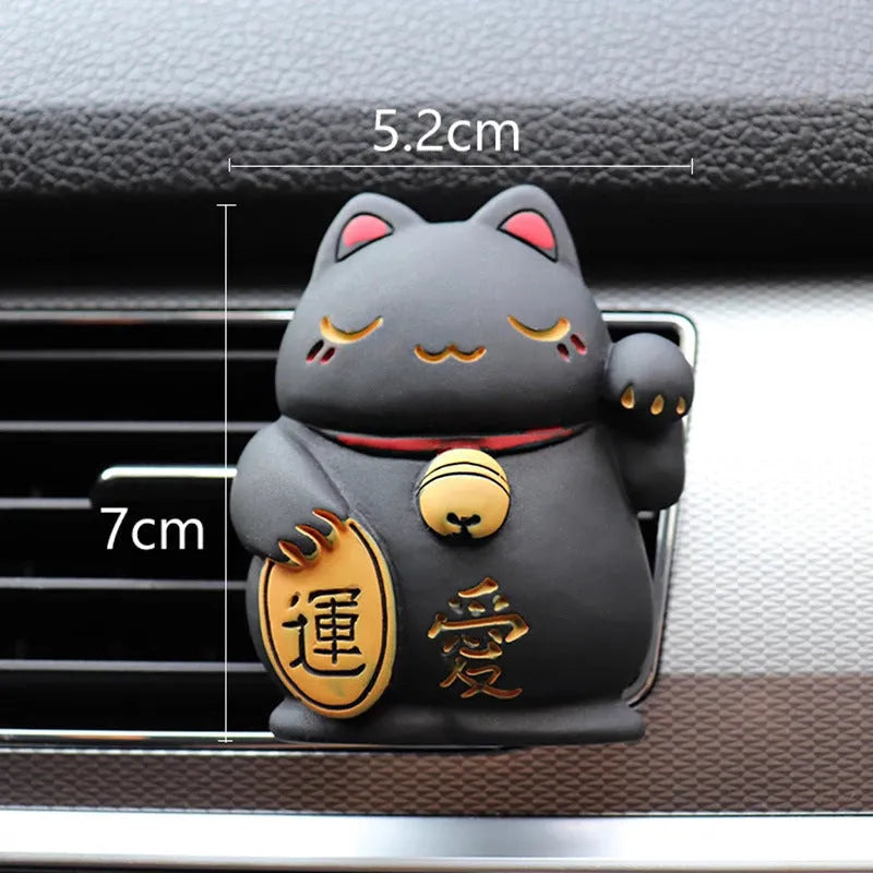 Black cat and white cat resin car vent clip aromatherapy diffuser on a car air conditioning vent.