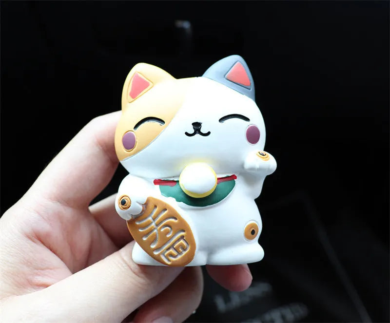 Black cat and white cat resin car vent clip aromatherapy diffuser on a car air conditioning vent.