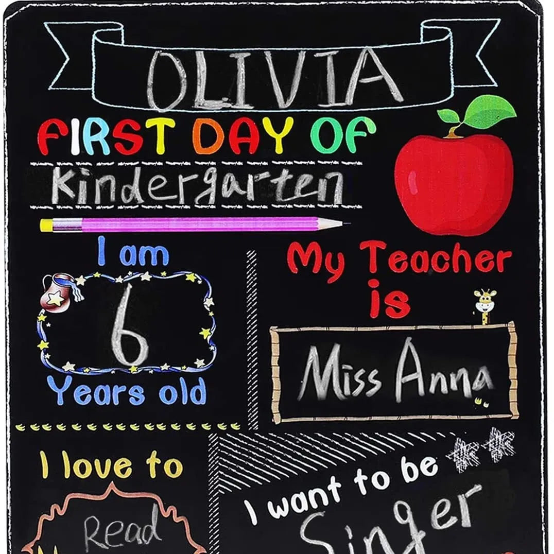 White modern wooden first day of school blackboard sign on a table.