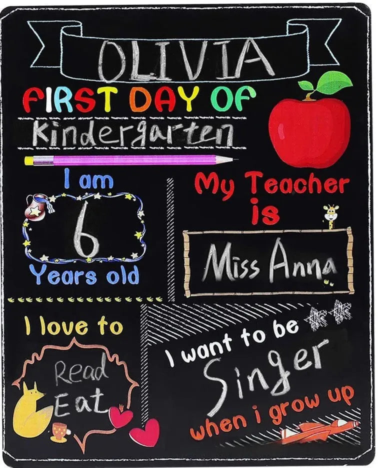 White modern wooden first day of school blackboard sign on a table.