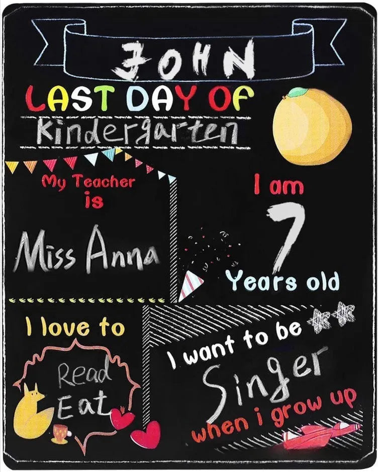 White modern wooden first day of school blackboard sign on a table.