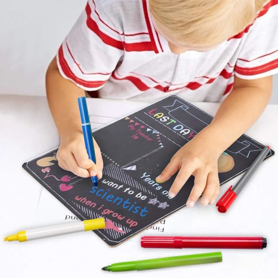 White modern wooden first day of school blackboard sign on a table.