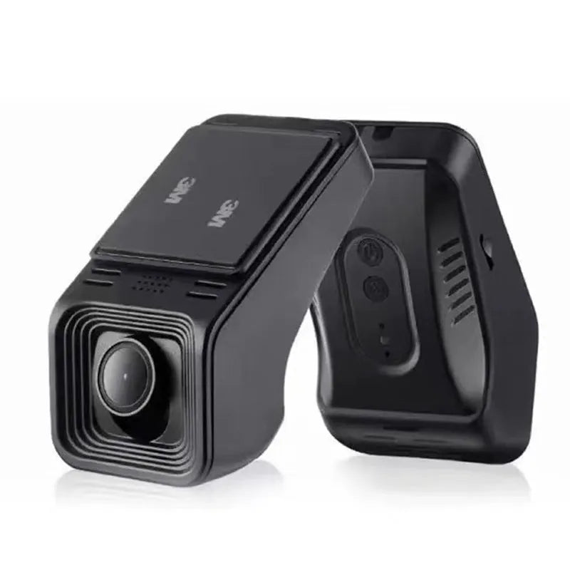 Black car dash cam mounted on windscreen with forward-facing lens and power cable