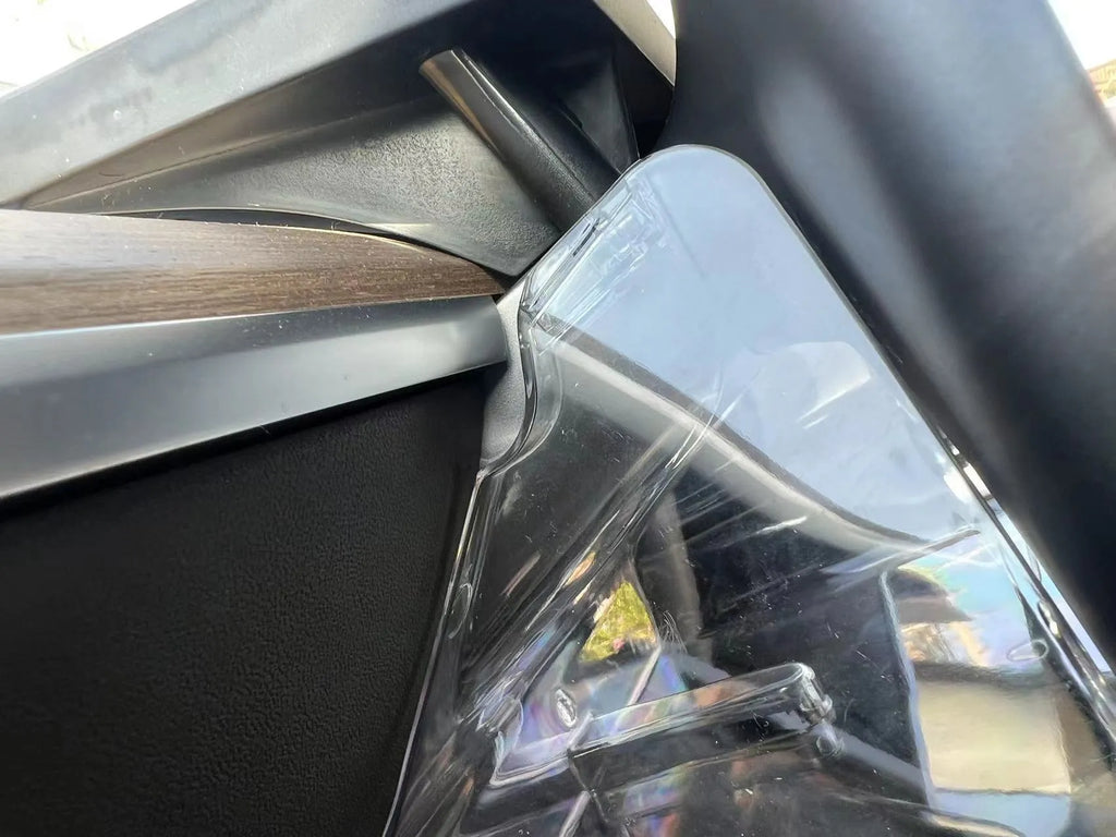 Black ABS plastic storage box installed under the screen of a Tesla Model Y centre console.