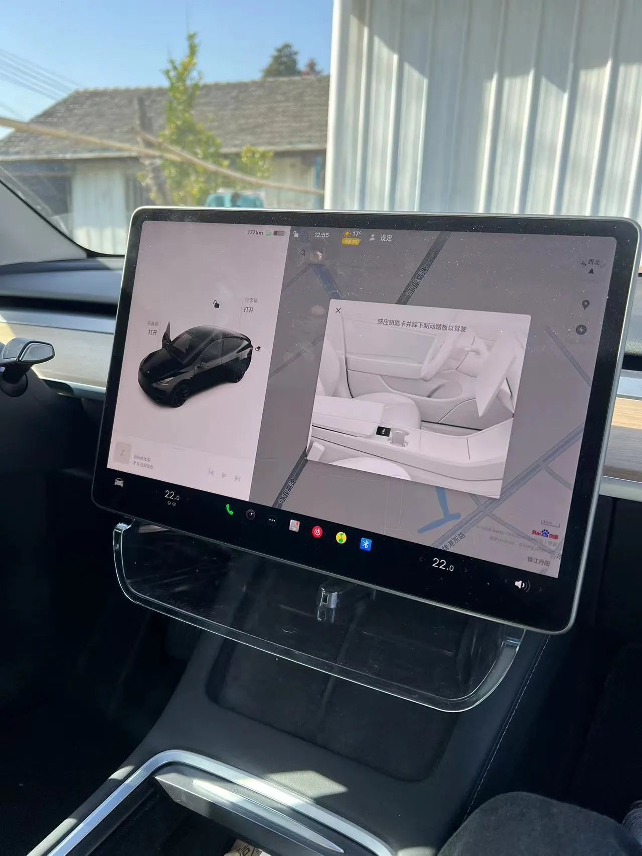 Black ABS plastic storage box installed under the screen of a Tesla Model Y centre console.