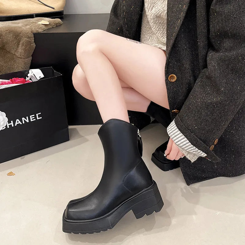 Black platform Martin boots for women with square toe and back zipper on a mid-calf.