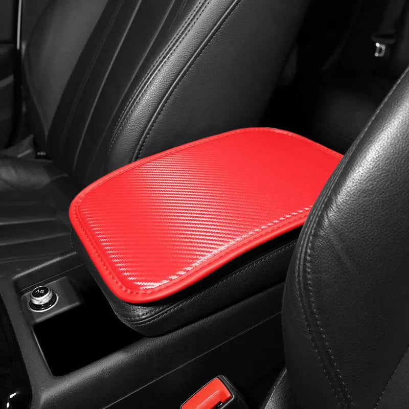 Automotive carbon fibre armrest box mat in black leather, 29x19cm, on a car centre console
