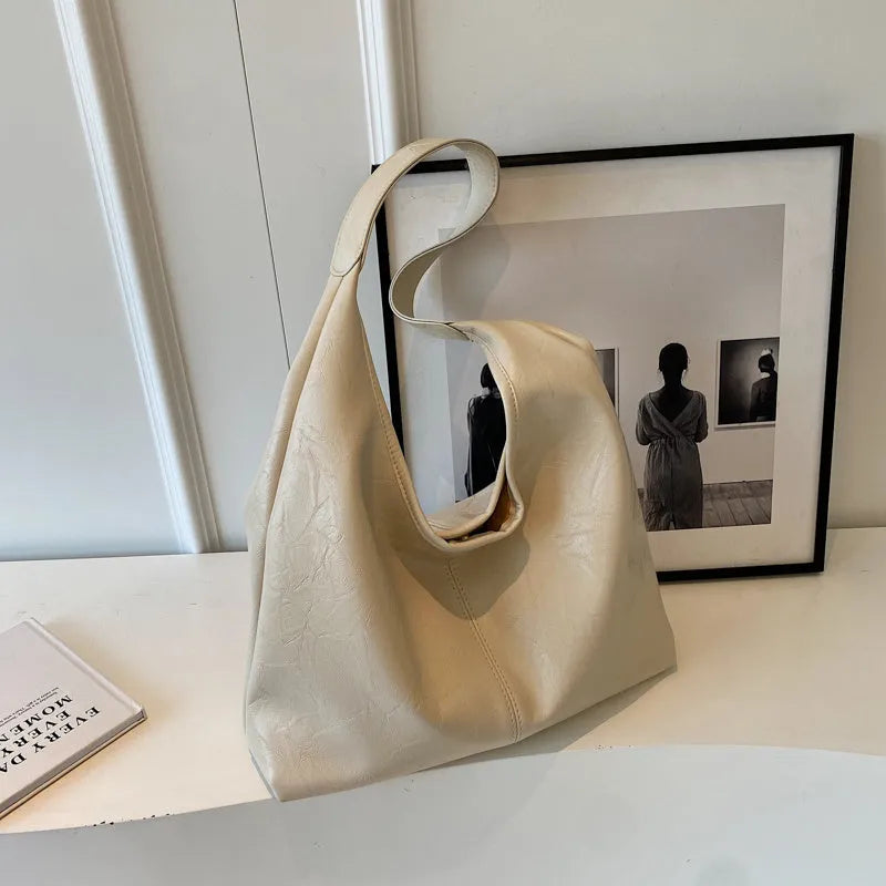 Casual soft PU leather shoulder bag in street trend style with large capacity and sandwich pocket.