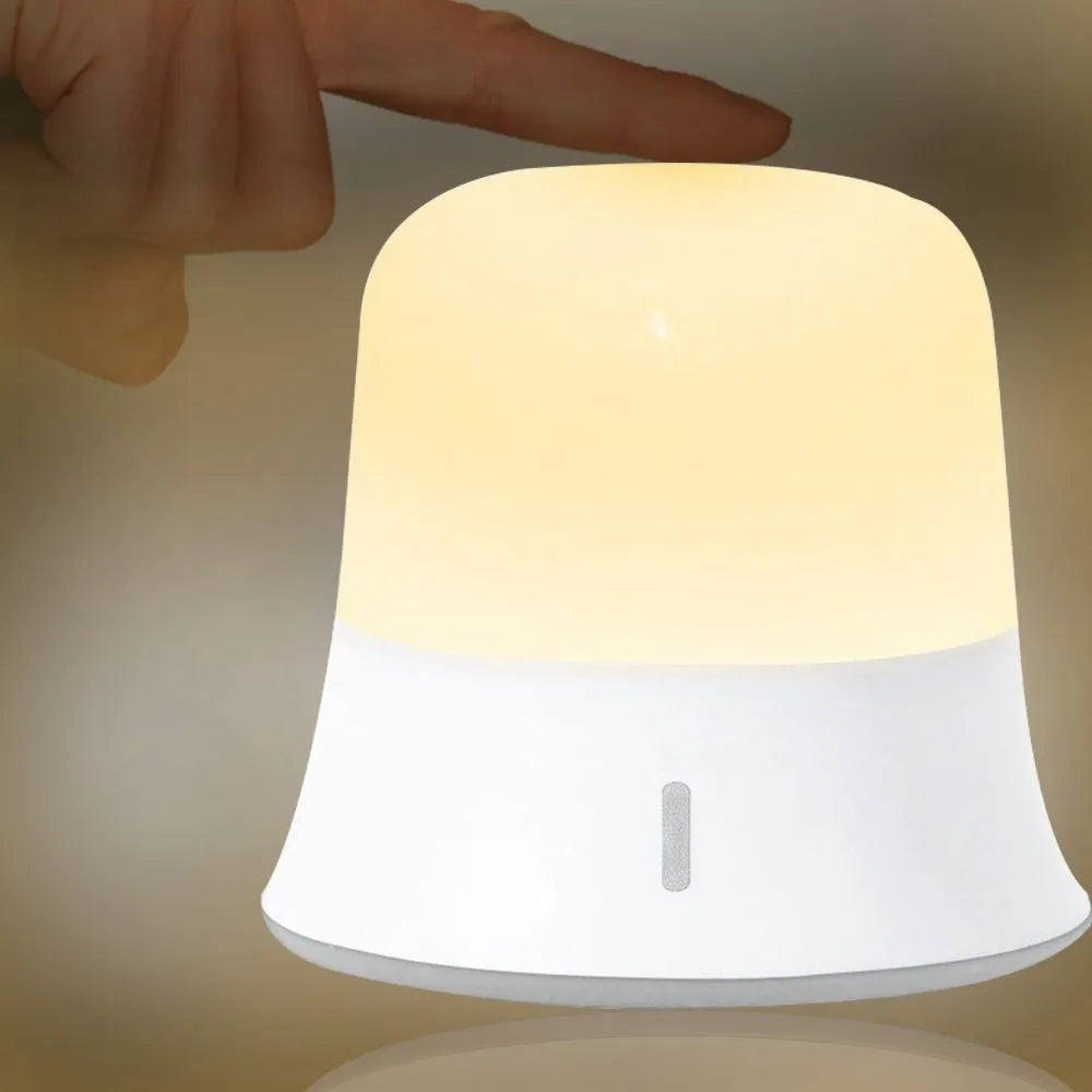 White bedside touch control night light with motion sensor, shown with warm white glow.