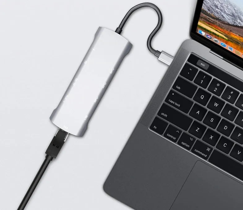 Grey USB-C docking station with HDMI, VGA, and USB ports on aluminium alloy body