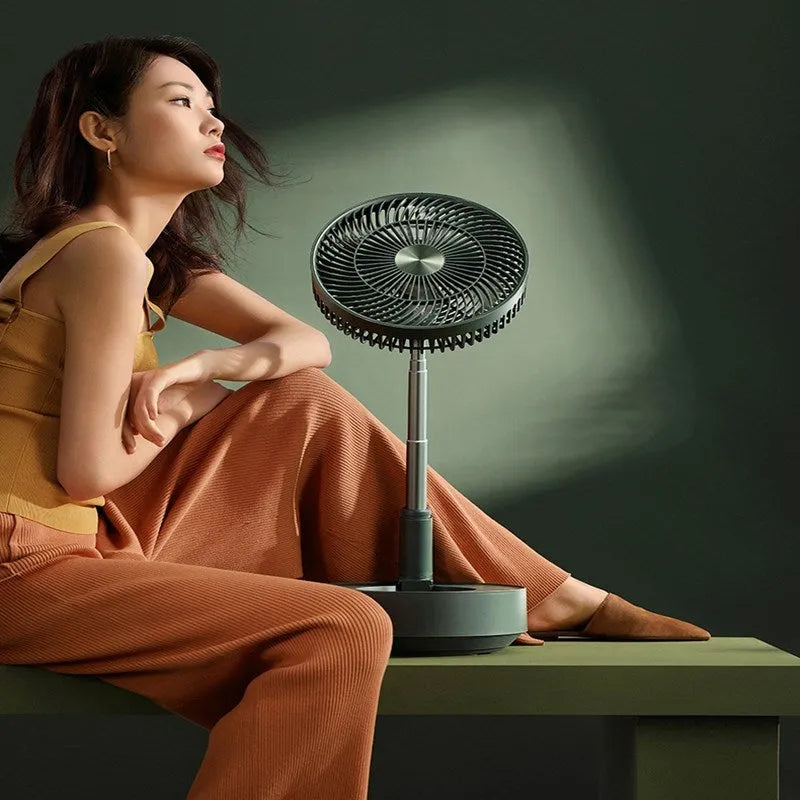 Green telescopic rechargeable electric fan showing extended floor-standing position with remote control