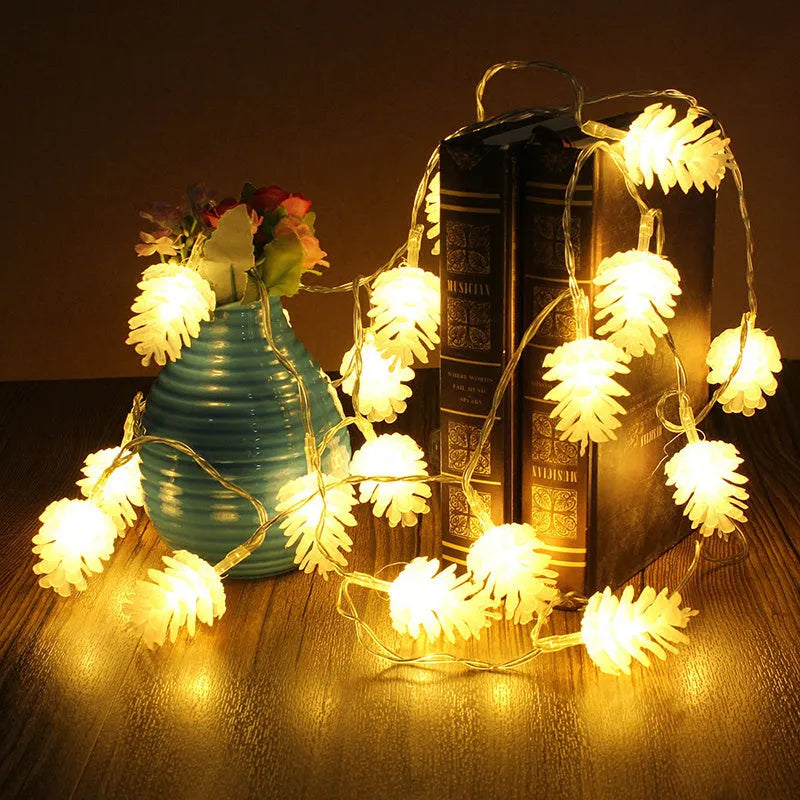 Warm white battery-powered LED pine cone lights on a string for festive decoration.