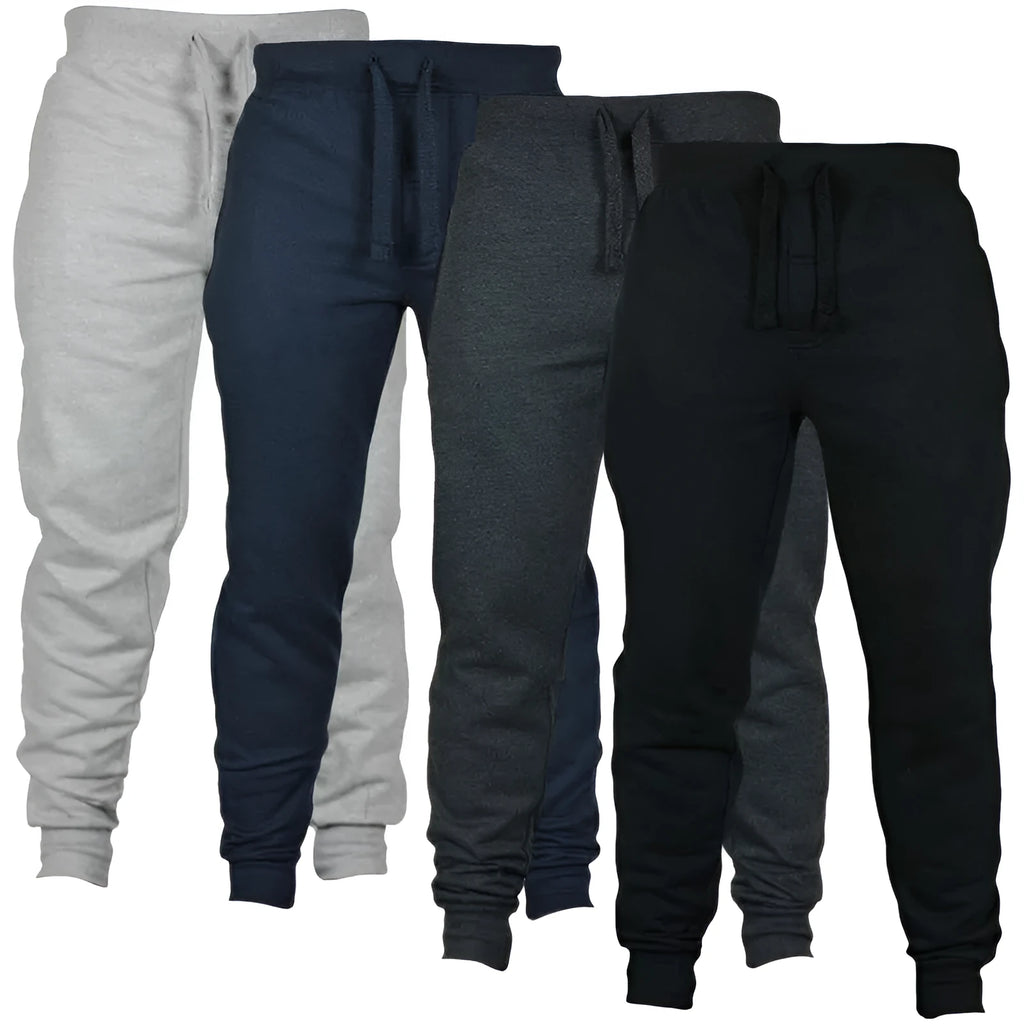 Man wearing solid colour cotton fleece drawstring trousers with a loose fit.