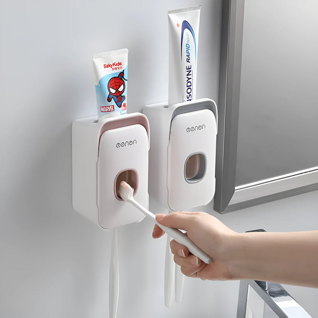 Blue automatic toothpaste dispenser mounted on bathroom wall with one-touch dispensing mechanism