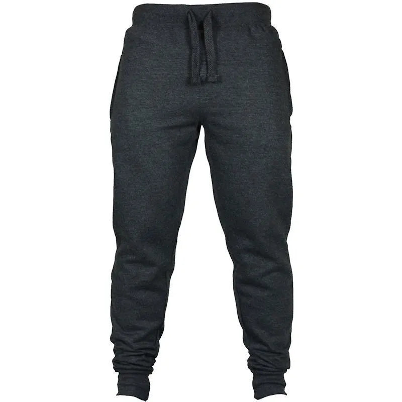 Man wearing solid colour cotton fleece drawstring trousers with a loose fit.