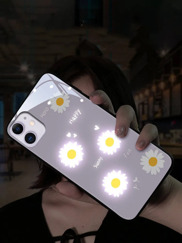 Luminous phone case for iPhone with voice-activated colour light showing painted daisy design on white TPU material