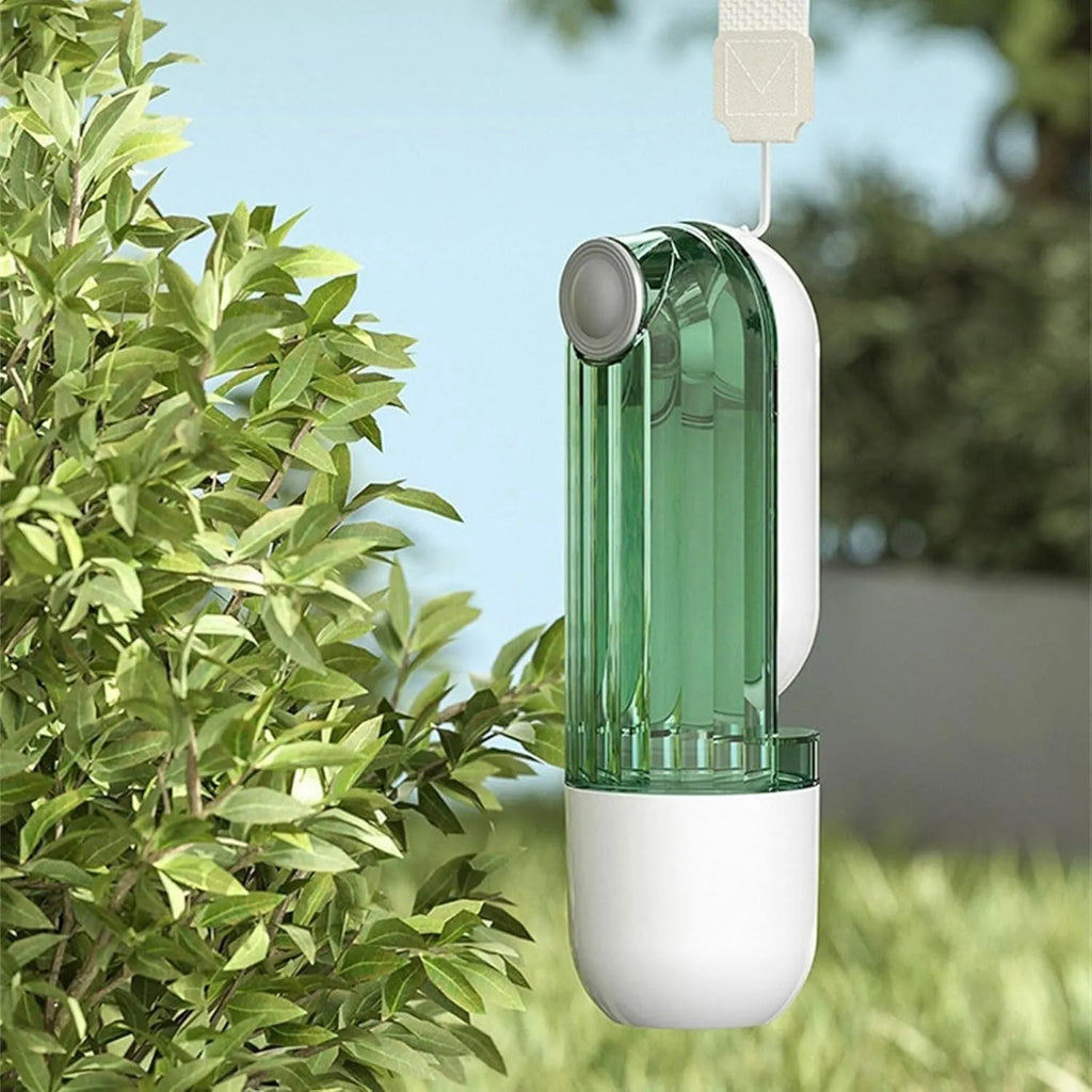 Beige and green foldable dog water bottle with food dispenser base for outdoor walking and travel.