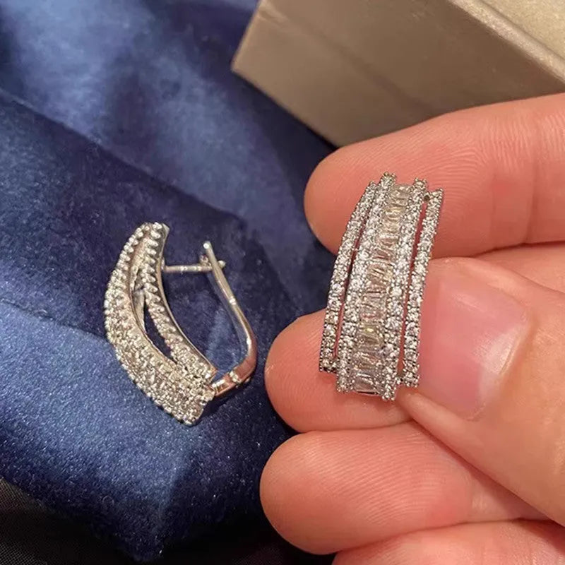 A pair of geometric-shaped stud earrings with zircon stones in a white gold colour.