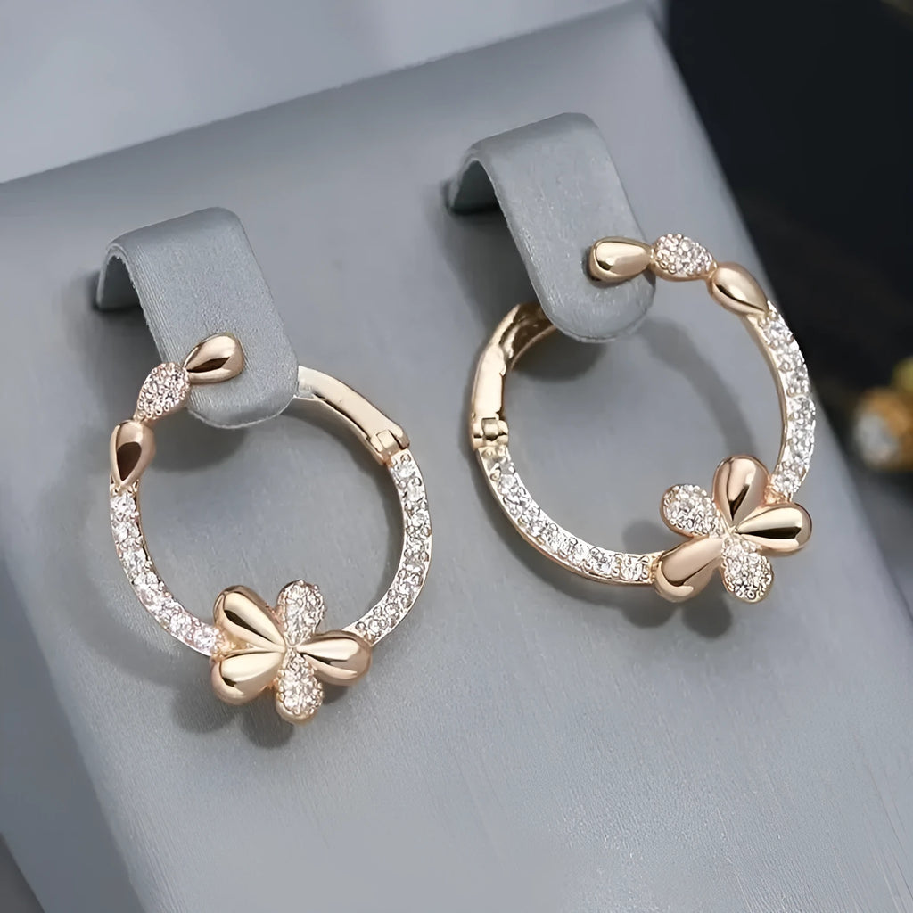A pair of geometric round ring earrings for women in an electroplated copper finish.